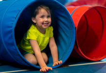 toddler playing in tunnel