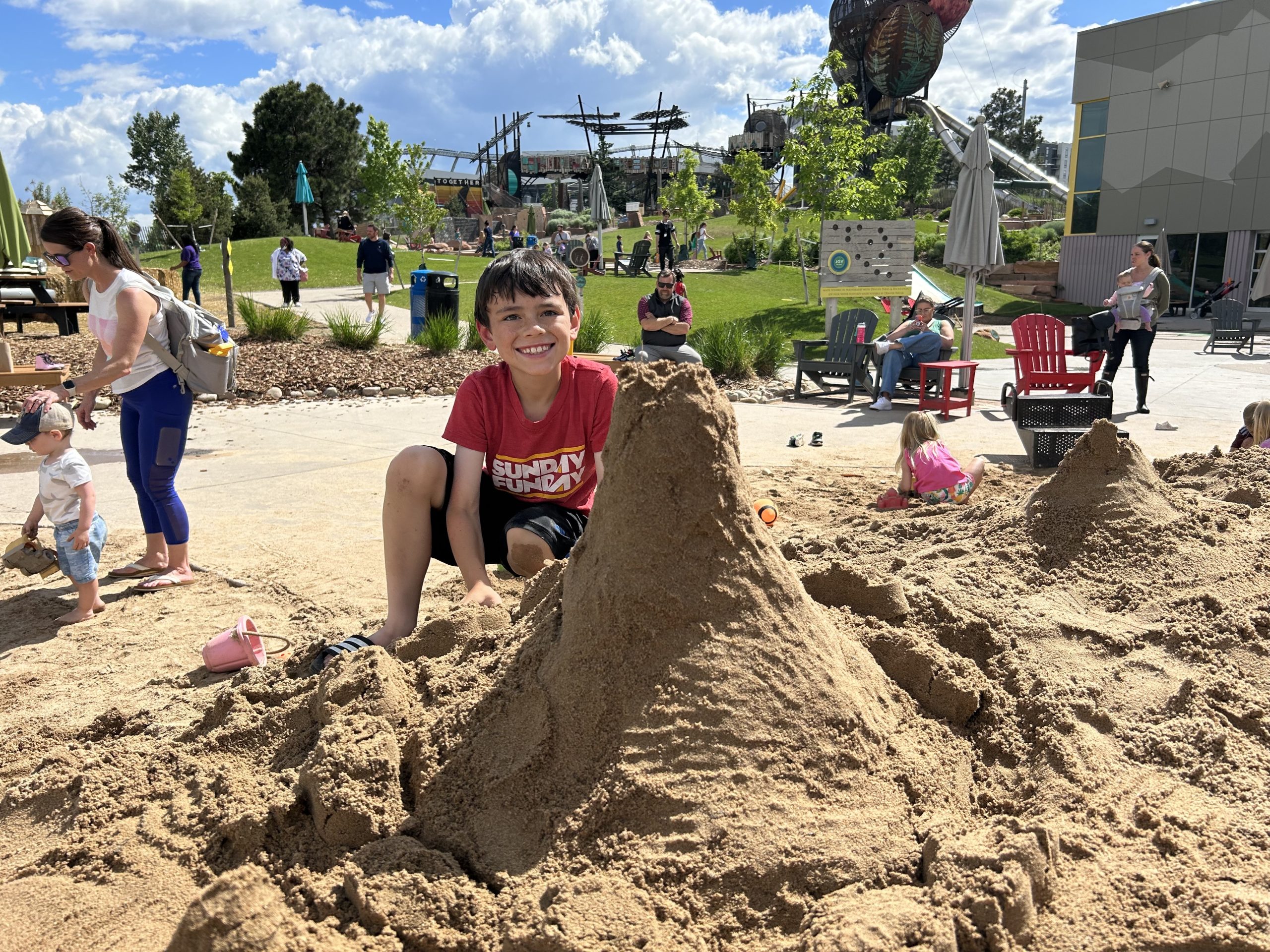 boy playing in sand at Joy Park